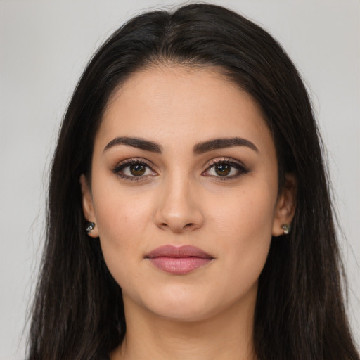 Joyful latino young-adult female with long  brown hair and brown eyes