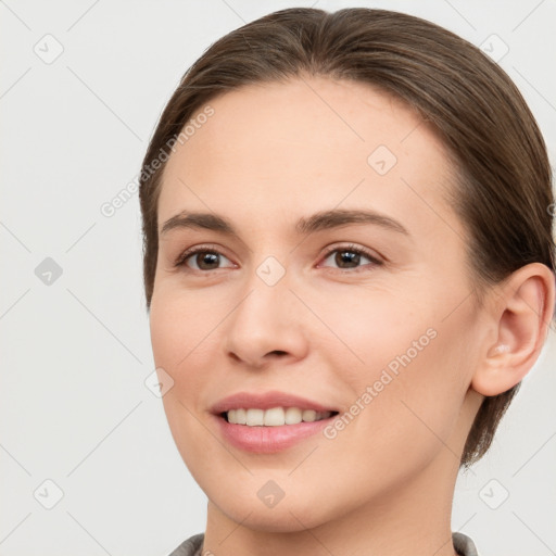 Joyful white young-adult female with medium  brown hair and brown eyes