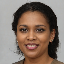 Joyful black young-adult female with medium  brown hair and brown eyes