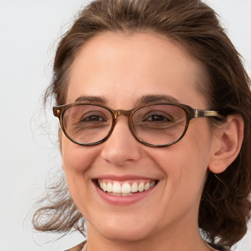 Joyful white adult female with medium  brown hair and brown eyes