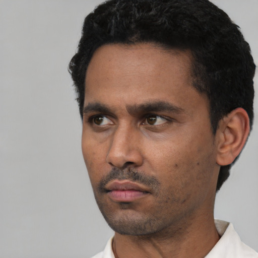 Neutral latino adult male with short  black hair and brown eyes