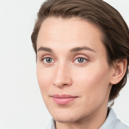 Joyful white young-adult female with short  brown hair and grey eyes