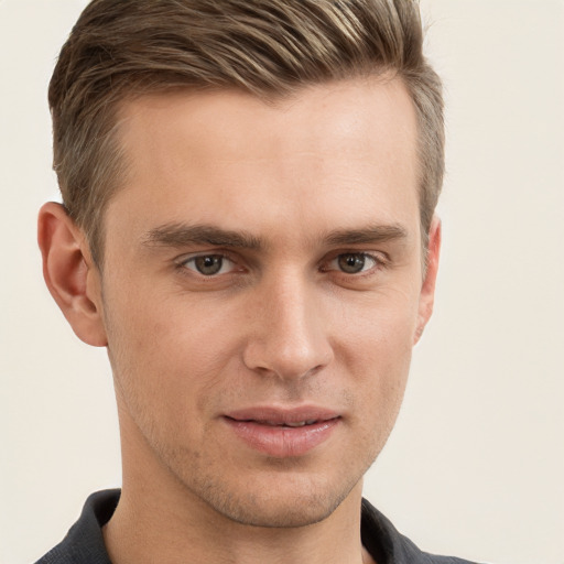 Joyful white young-adult male with short  brown hair and grey eyes