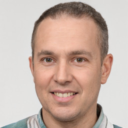 Joyful white adult male with short  brown hair and brown eyes