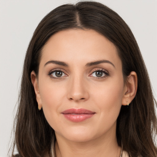 Joyful white young-adult female with long  brown hair and brown eyes