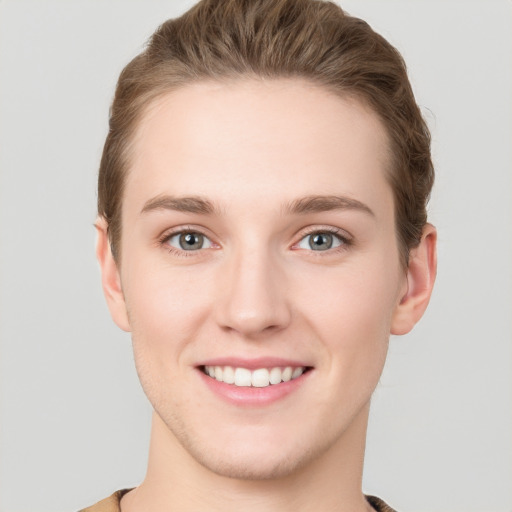 Joyful white young-adult female with short  brown hair and grey eyes