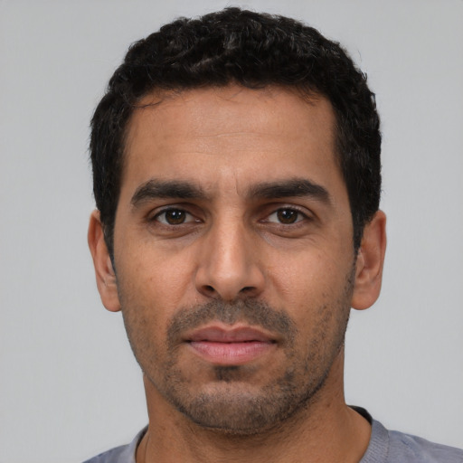 Neutral latino young-adult male with short  black hair and brown eyes