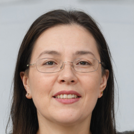 Joyful white adult female with long  brown hair and brown eyes