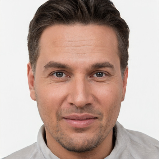 Joyful white adult male with short  brown hair and brown eyes