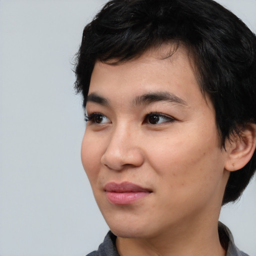 Joyful asian young-adult male with medium  black hair and brown eyes