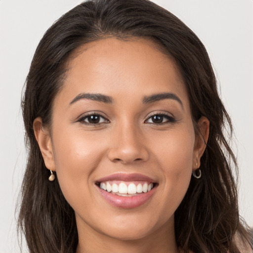 Joyful white young-adult female with long  brown hair and brown eyes