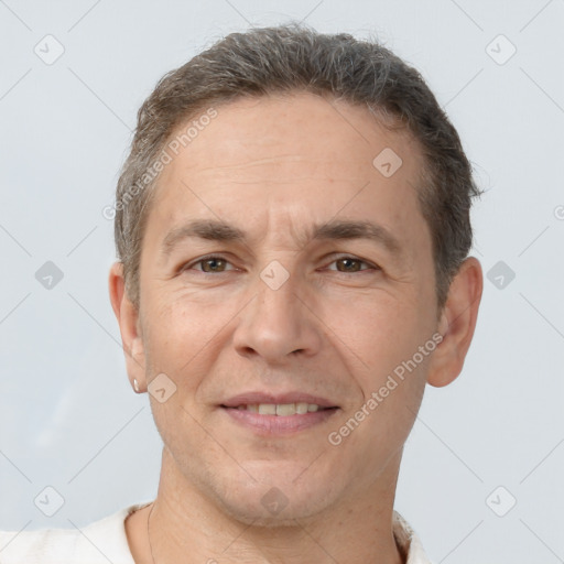 Joyful white adult male with short  brown hair and brown eyes