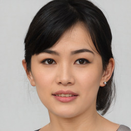 Joyful asian young-adult female with medium  black hair and brown eyes