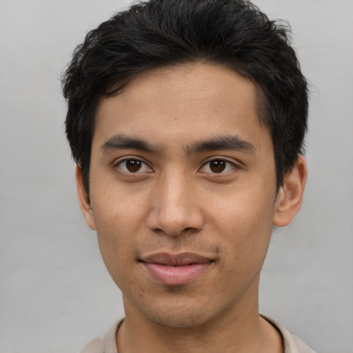 Joyful asian young-adult male with short  brown hair and brown eyes