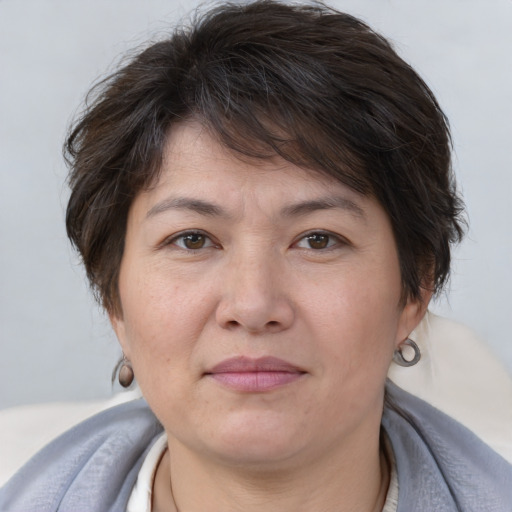 Joyful white adult female with short  brown hair and brown eyes