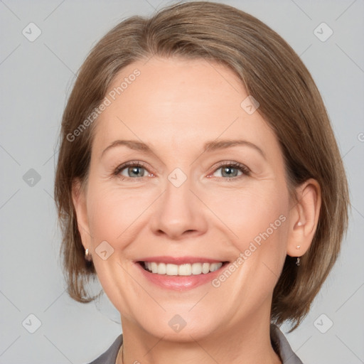 Joyful white adult female with medium  brown hair and grey eyes