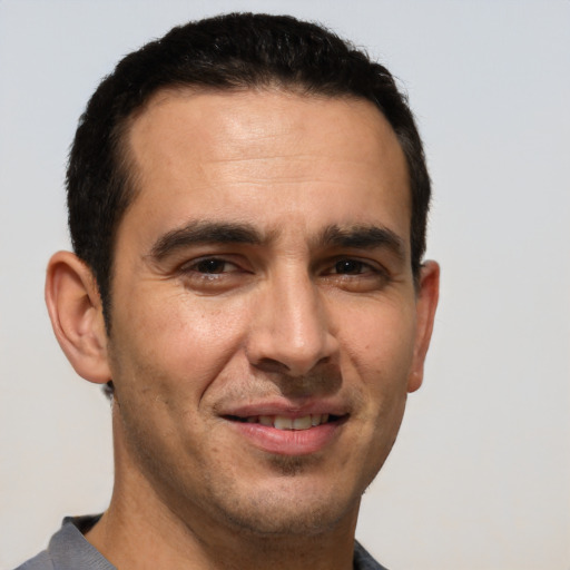 Joyful white adult male with short  brown hair and brown eyes