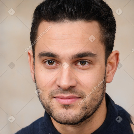 Joyful white young-adult male with short  black hair and brown eyes