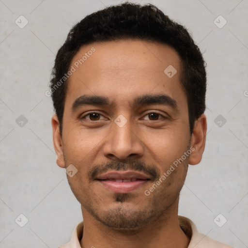 Joyful latino young-adult male with short  black hair and brown eyes