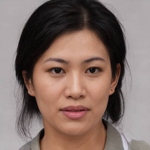 Joyful asian young-adult female with medium  brown hair and brown eyes