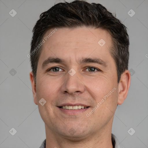 Joyful white adult male with short  brown hair and grey eyes