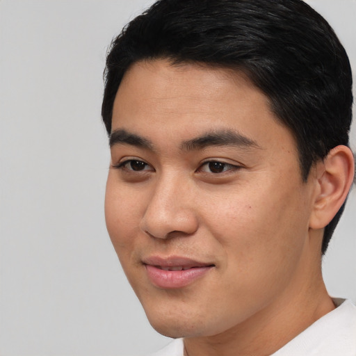 Joyful asian young-adult male with short  black hair and brown eyes