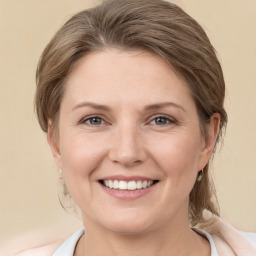 Joyful white young-adult female with medium  brown hair and grey eyes