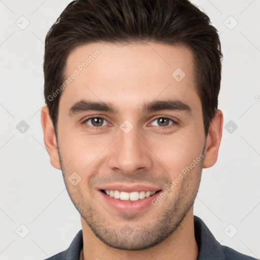 Joyful white young-adult male with short  brown hair and brown eyes