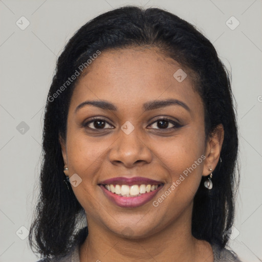 Joyful black young-adult female with long  brown hair and brown eyes