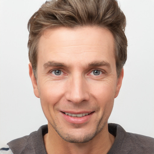 Joyful white adult male with short  brown hair and grey eyes