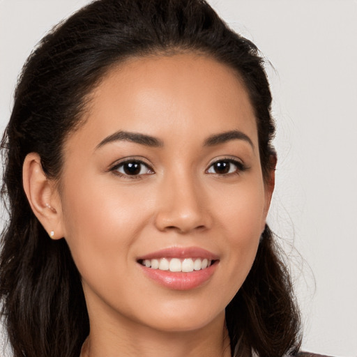 Joyful white young-adult female with long  brown hair and brown eyes