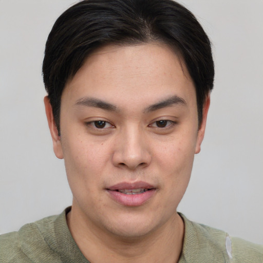 Joyful asian young-adult male with short  brown hair and brown eyes