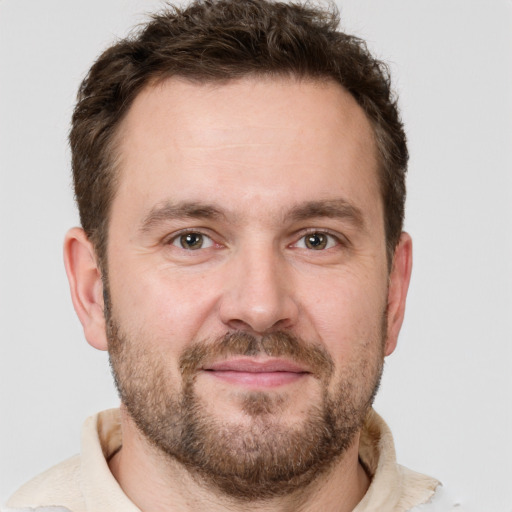 Joyful white adult male with short  brown hair and brown eyes