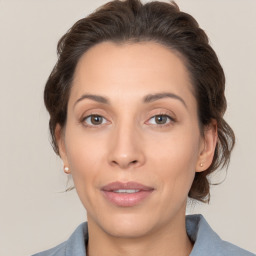 Joyful white adult female with medium  brown hair and brown eyes