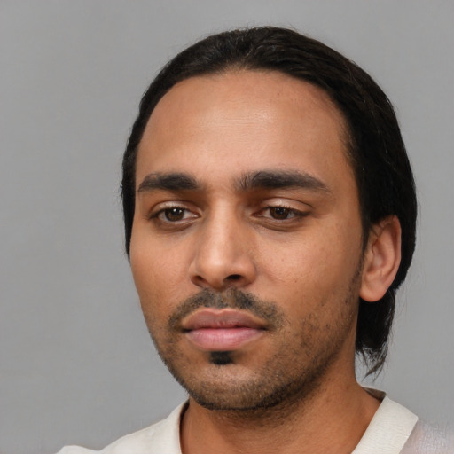 Neutral latino young-adult male with short  black hair and brown eyes