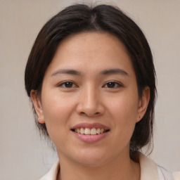 Joyful white young-adult female with medium  brown hair and brown eyes