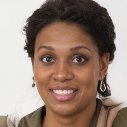 Joyful black adult female with long  brown hair and brown eyes