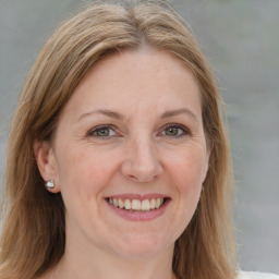 Joyful white adult female with medium  brown hair and blue eyes