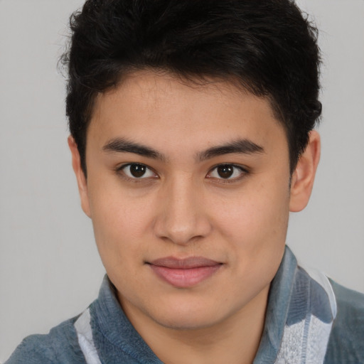 Joyful latino young-adult male with short  brown hair and brown eyes