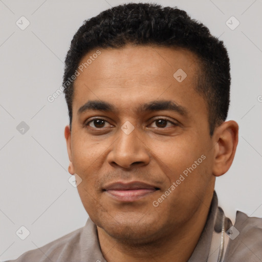 Joyful latino young-adult male with short  black hair and brown eyes