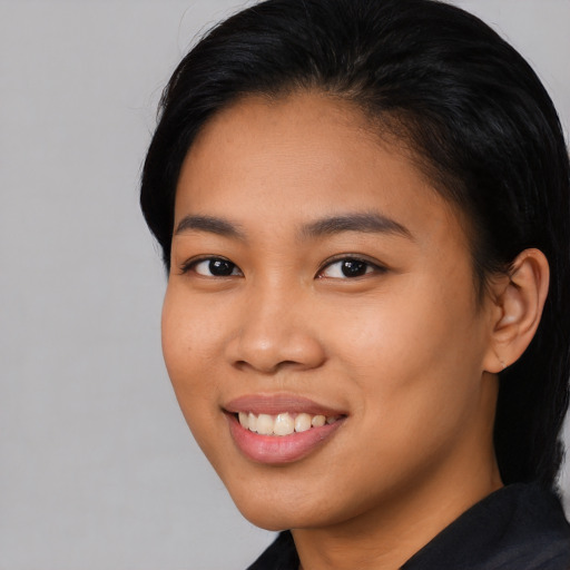 Joyful asian young-adult female with medium  black hair and brown eyes