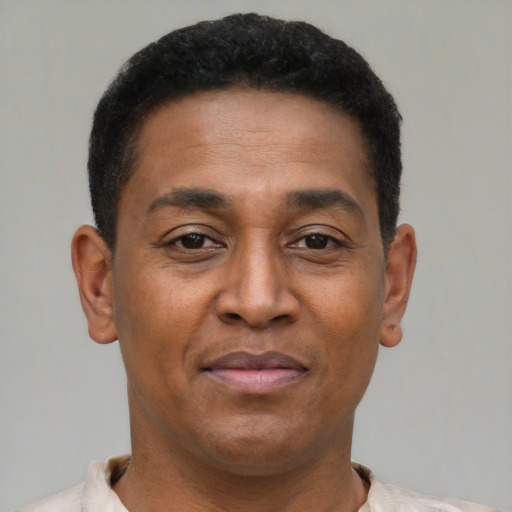Joyful latino young-adult male with short  brown hair and brown eyes