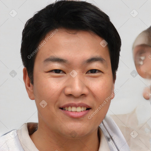 Joyful asian young-adult male with short  brown hair and brown eyes