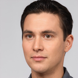 Joyful white young-adult male with short  brown hair and brown eyes