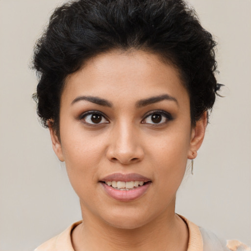 Joyful latino young-adult female with short  black hair and brown eyes
