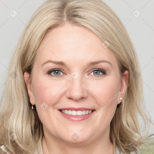 Joyful white adult female with medium  brown hair and blue eyes