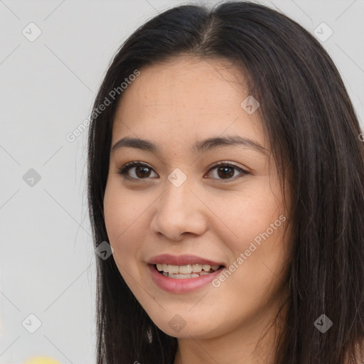 Joyful asian young-adult female with long  brown hair and brown eyes