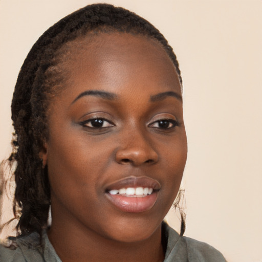 Joyful black young-adult female with long  brown hair and brown eyes