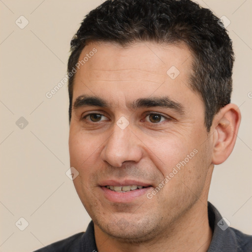 Joyful white adult male with short  black hair and brown eyes