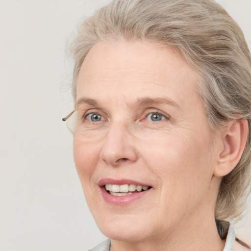 Joyful white adult female with medium  brown hair and blue eyes